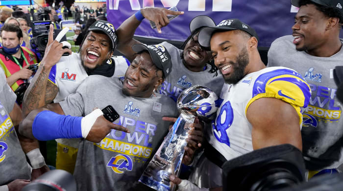 Los Angeles Rams players celebrate with the Lombardi Trophy after defeating the Cincinnati Bengals in the NFL Super Bowl 56 football game Sunday, Feb. 13, 2022, in Inglewood, Calif.